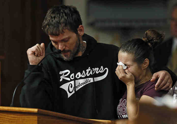 Jennifer Castle (right) can't read her victim impact statement so her fiancé Jason North reads it at the Pickaway County Common Pleas Court in Circleville.  Castle's son, 16-year-old Samuel Nicholson II, was shot and killed by Justin Blevins.  Blevins was sentenced to life in prison with no chance of parole for 37 years.    (Kyle Robertson / The Columbus Dispatch)